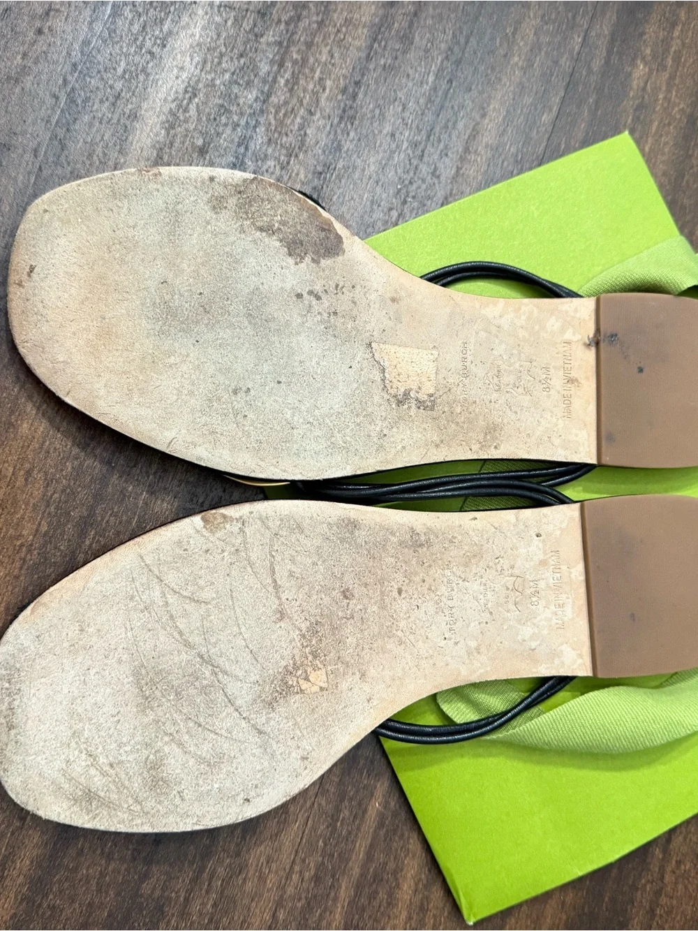 Tory Burch Patos Disk Leather Thong Sandals in black with gold-tone medallions